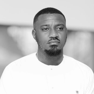 "My Mother Wanted Me To Be A Reverend Father" - John Dumelo Shares Throwback Photo
