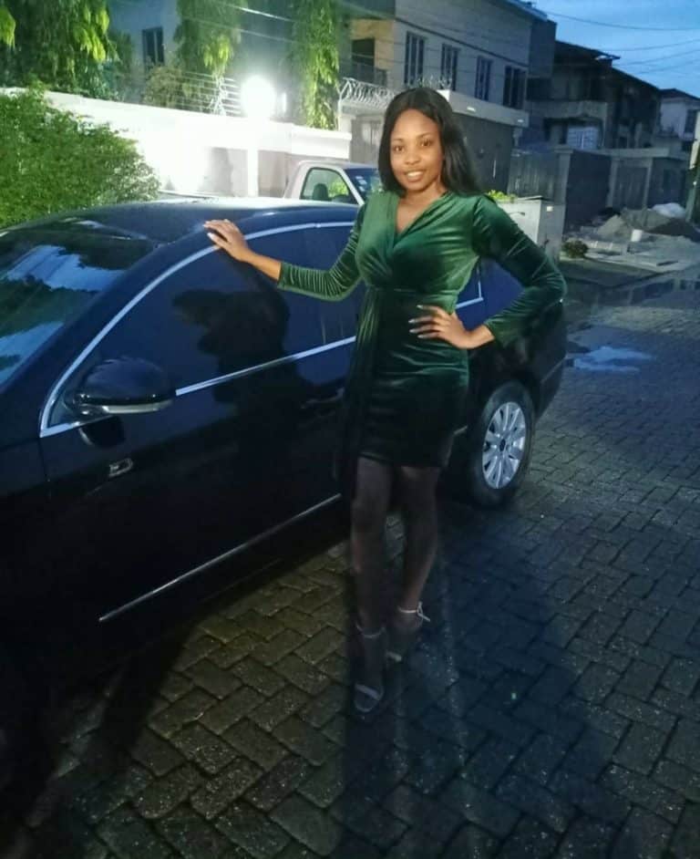 Cindy Okafor poses in front of her car