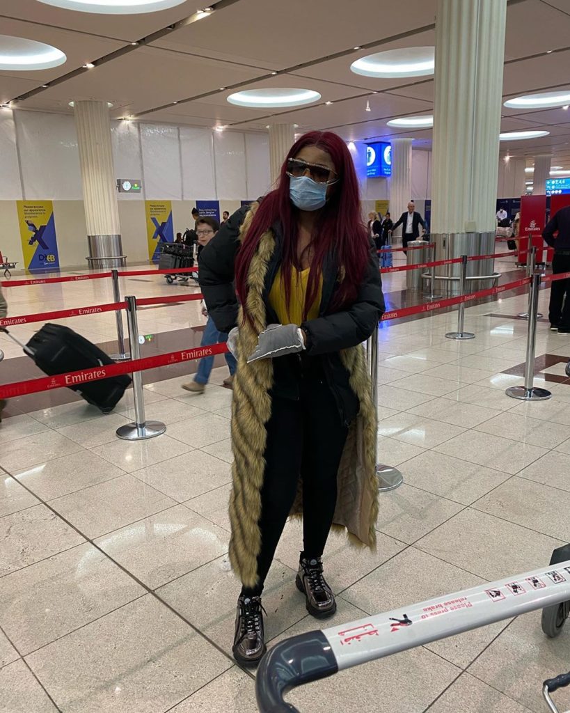 Tacha posing for photo at the airport