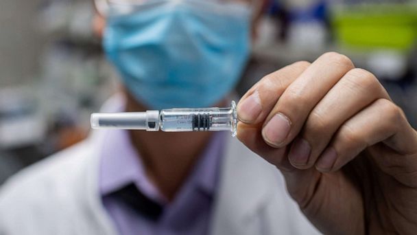 PHOTO: An engineer displays an experimental vaccine for the COVID-19 coronavirus that was tested at the Quality Control Laboratory at the Sinovac Biotech facilities in Beijing, April 29, 2020. (Nicolas Asfouri/AFP via Getty Images)