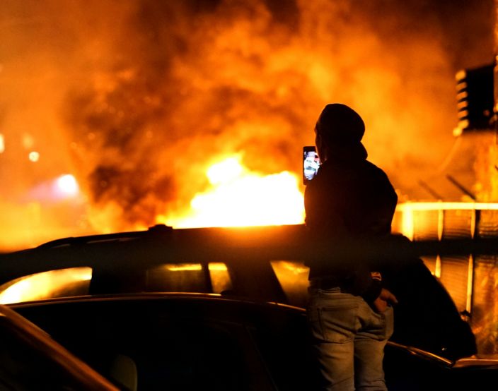 Several cars burn near a gas station during a night of rioting in Minneapolis over the death of George Floyd in police custody.