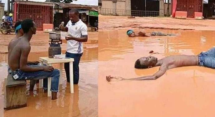 Imo Youths Cook And Swim In Muddy Water To Expose Terrible State Of A Road [Photos]