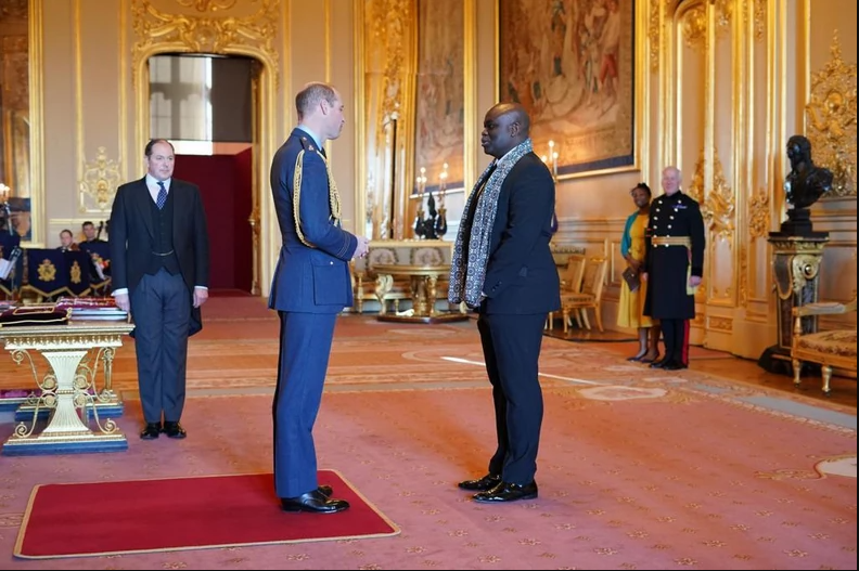 Gospel singer, Muyiwa Olarewaju receives an OBE medal from Prince William (photos)