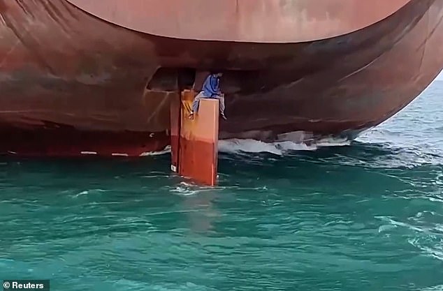 Nigerian migrants are spotted sitting on the rudder of the Liberian-flagged Ken Wave