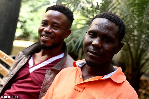 Thankgod Matthew (L) and Roman Ebimene (R) pose for a photo during an interview, after being rescued from a ship rudder on the Brazilian coast, in Sao Paulo, Brazil July 26