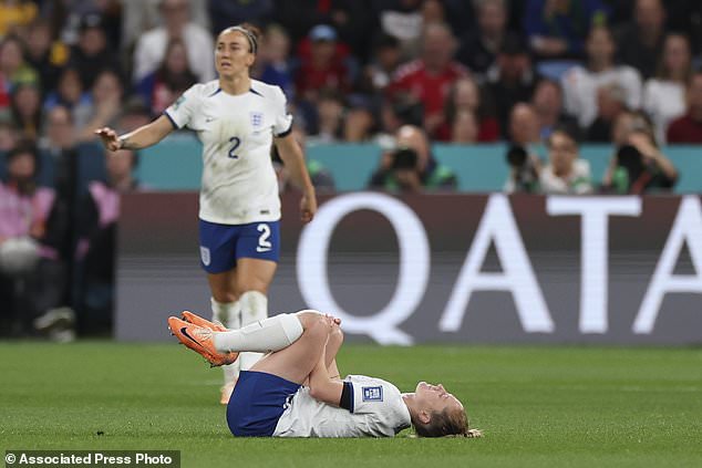 England's Keira Walsh holds her knee before being carried off the field during the Women's World Cup Group D soccer match between England and Denmark at Sydney Football Stadium in Sydney, Australia, Friday, July 28, 2023. (AP Photo/Sophie Ralph)